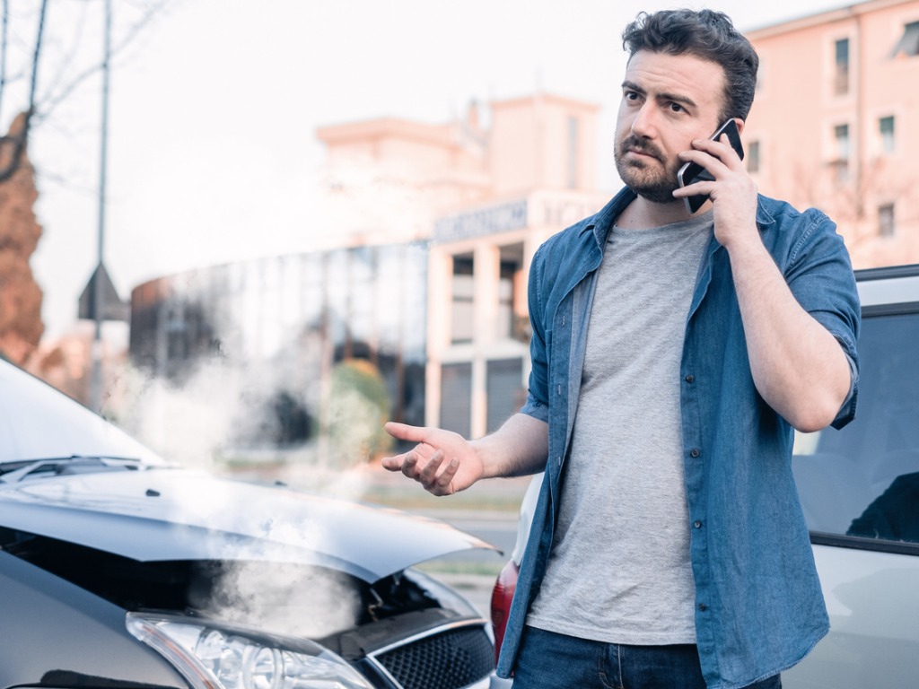 Accident victim calling for help after a car accident using the Uber app